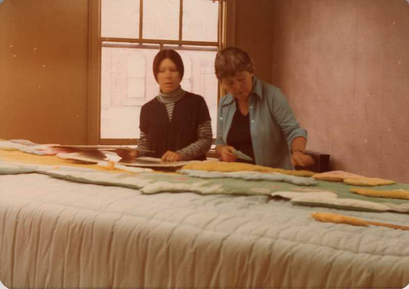 Joyce Wieland (left) laying out the Caribou Quilt now located at Spadina Station on the TTC.