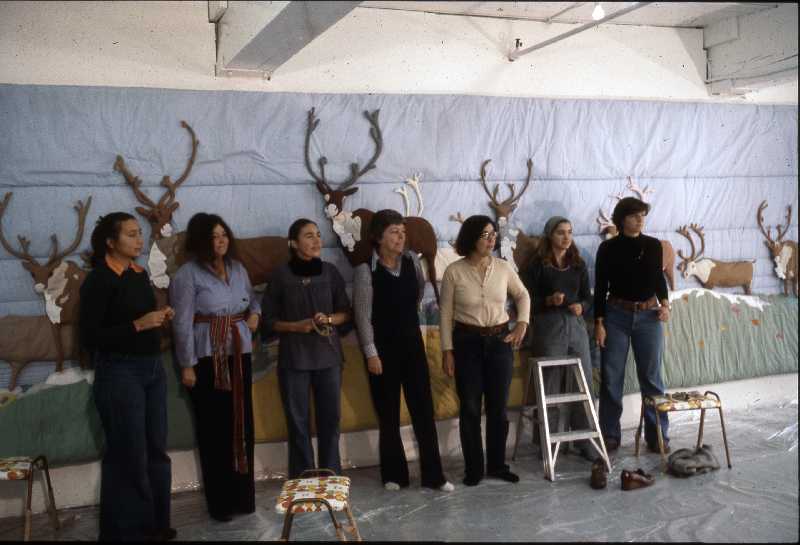 Joyce Wieland with assistants standing in front of the Caribou Quilt, 1977
