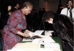Participants signing a guest book at the first federal celebration of Black History Month, 13 February, 1996. Image no. ASC04451.